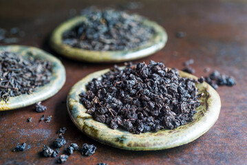 loose leaf black tea on ceramic plates.