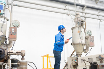 The European male engineer operates within the industrial plant, where he efficiently manages machinery, crucial for plastic and steel production geared towards global markets.