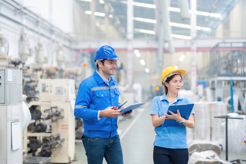In the dynamic environment of the industrial plant, the European male engineer and the Asian female...