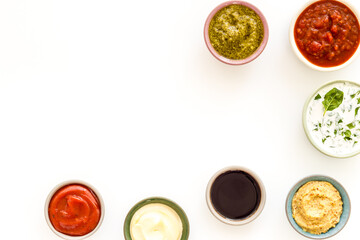 Set of sauces in bowls - pesto salsa mustard and others. Food background
