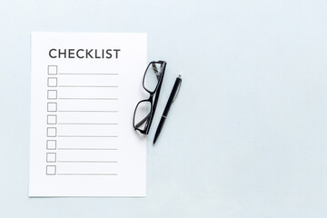 Checklist concept. Blank checklist with empty boxes on office table