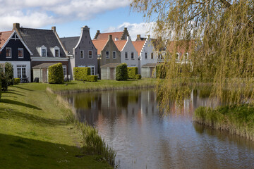 Naklejka na ściany i meble Houses and canal at Eson Stad. Eson city. Friesland Netherlands. Replica city. Lauwerszee. Lauwersoog. Waddenzee. 