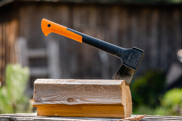 A carpenter tool an ax sticks out of a log - woodcutter workplace