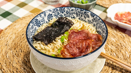 Japanese soup with noodles, meat, chives and seaweed