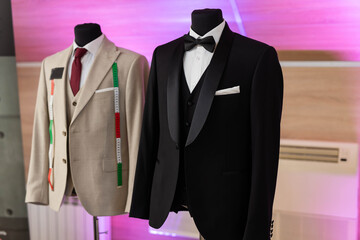stylish men's suits on mannequins in the studio	