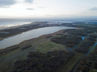 Aerial landscape of lake and beach on IJmuiden at sunset by North Sea in North Holland - obrazy, fototapety, plakaty