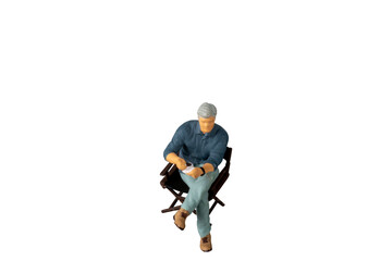 A businessman seated on a chair and sipping hot coffee isolated on white background with clipping path