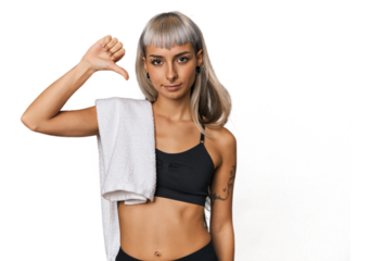 Caucasian young woman in sportswear showing a dislike gesture, thumbs down. Disagreement concept.