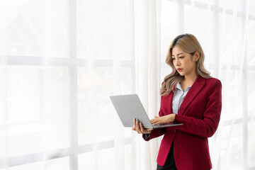 Engineer points to building on blueprint and uses laptop to draw building design project in office
A home architect is reviewing a draft house plan. Projects assigned by customers and designs