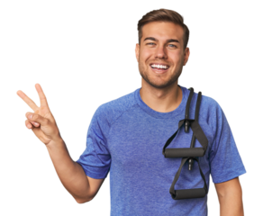 Athlete with resistance band joyful and carefree showing a peace symbol with fingers.