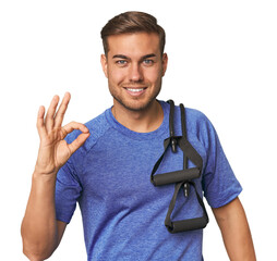 Athlete with resistance band cheerful and confident showing ok gesture.