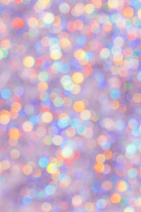 Defocused abstract bokeh background pastel colored, flare from lights, color gradient, blurred circle bokeh as holiday texture. Glittering aesthetic textured lighting pattern