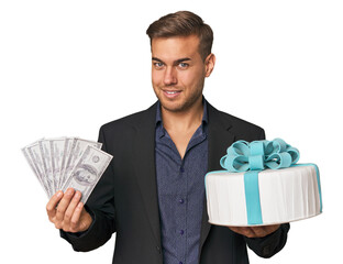 Young man with dollars and cake, merging finance with celebration