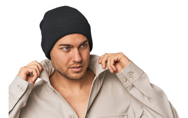 Close-up of a young man in a wool hat, showcasing winter fashion