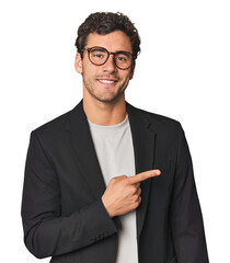 Young Hispanic businessman smiling and pointing aside, showing something at blank space.