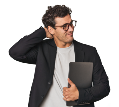 Young Hispanic businessman with laptop touching back of head, thinking and making a choice.