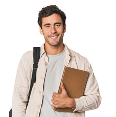 Young Hispanic student with notebook happy, smiling and cheerful.