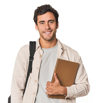 Young Hispanic student with notebook happy, smiling and cheerful.