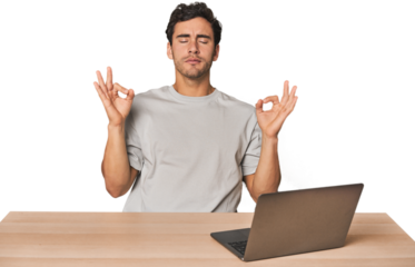 Hispanic young man working on laptop relaxes after hard working day, she is performing yoga.