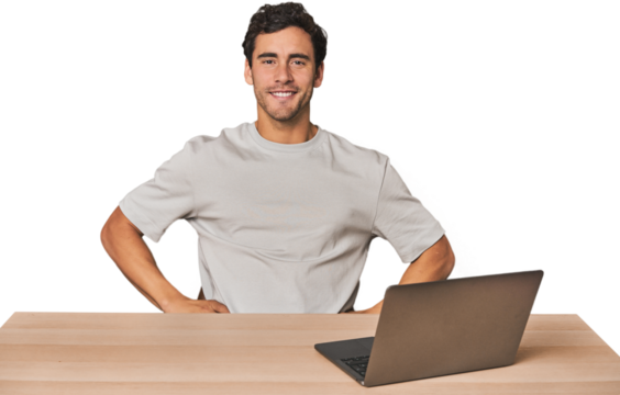 Hispanic young man working on laptop confident keeping hands on hips.