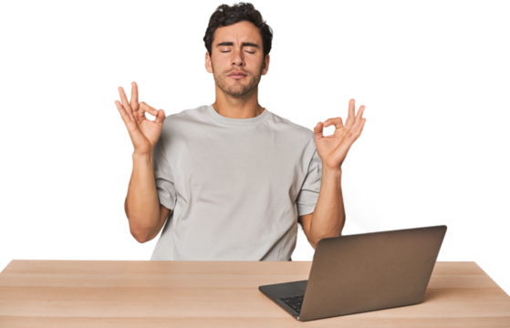 Hispanic young man working on laptop relaxes after hard working day, she is performing yoga.