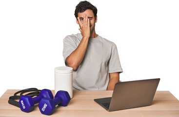 Hispanic trainer planning workout blink at the camera through fingers, embarrassed covering face.