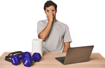 Hispanic trainer planning workout blink at the camera through fingers, embarrassed covering face.