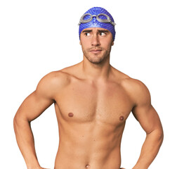 Young Hispanic man with swim gear confused, feels doubtful and unsure.