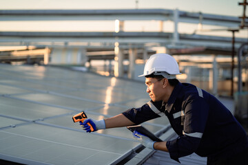 A man is working on a solar panel, using a device to measure the temperature. Concept of precision and technical expertise, as the man is focused on his task