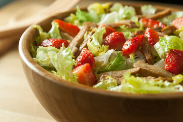 Front view of tibia lettuce salad with strawberries and chicken