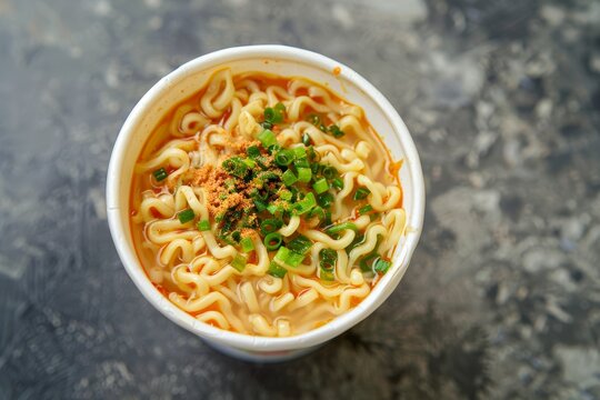 Precooked dried noodle block with flavoring sold in cup