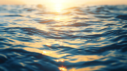 The image captures the serene beauty of a sunset reflecting golden hues off the gentle ocean waves, creating a peaceful atmosphere