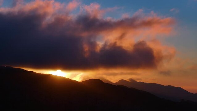 Sunset clouds in Los Machucos at 921 meters above sea level and communicates the villages of Bustablado and San Roque de Riomiera. Pasiegos Valleys, Cantabria, Spain, Europe