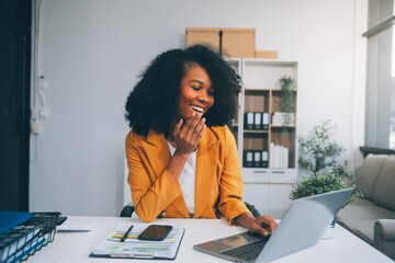 Asian Businesswoman Using laptop computer and working at office with calculator document on desk,...