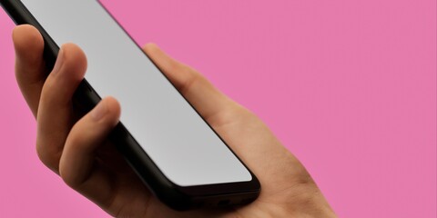 Hand holding smartphone on pink background, ideal for vibrant app displays