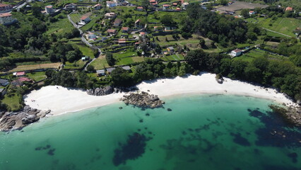 Nature's Palette: Aerial View of Turquoise Waters, Coastal Rocks, and Lush Greenery
