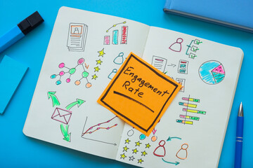 Engagement rate concept. Open notepad with graphs, charts and sticky note.