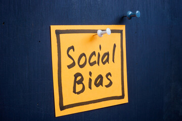 A piece of paper with an inscription social bias is pinned to the board. - obrazy, fototapety, plakaty