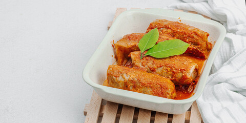 Cabbage rolls stuffed with rice and meat stewed in tomato sauce. Traditional dish, ready-to-eat food