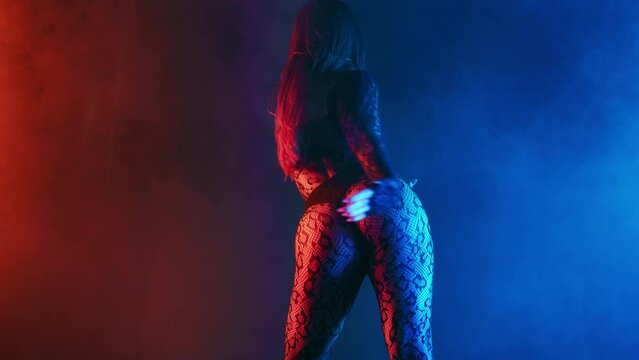 Sexy woman dancing, flexible body moves. Seductive hot private dance in neon studio. Beautiful alluring lady, freestyle contemporary show. 
