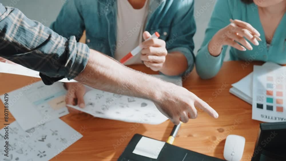 Poster close up of smart business team hands looking at color palette at table while throw paper in the air