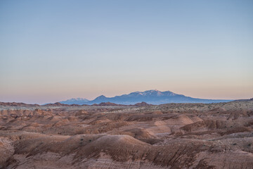 Gorgeous Desert Hills in Goblin Valley Utah Snow Capped Mountains Sunset