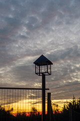 close up of a street lamp at sunset