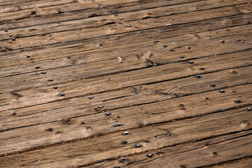 Worn, weathered wooden planks on a wooden pier in Santa Barbara, California (USA). Diagonal old...