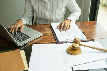 Judge gavel with Justice lawyers having team meeting at law firm background. Concepts of Law and...