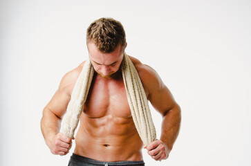 Handsome man with athletic wet body after shower.