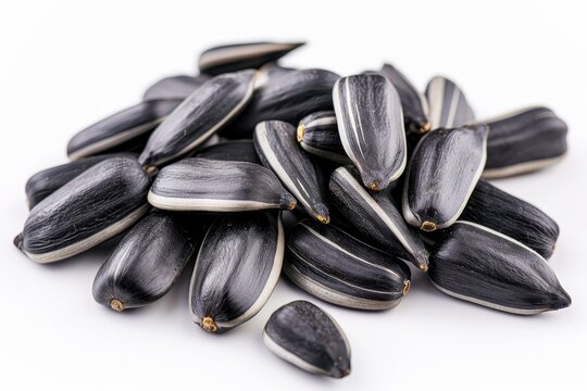 Close up of tasty black sunflower seeds on white backdrop