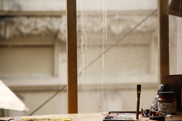 Capturing the essence of creativity, a single brush awaits its next stroke in the painter's...