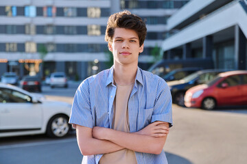 Portrait of college student guy looking at camera, urban outdoor