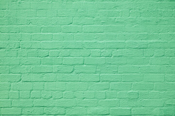 The brick wall is painted with green paint. Abstract construction background.